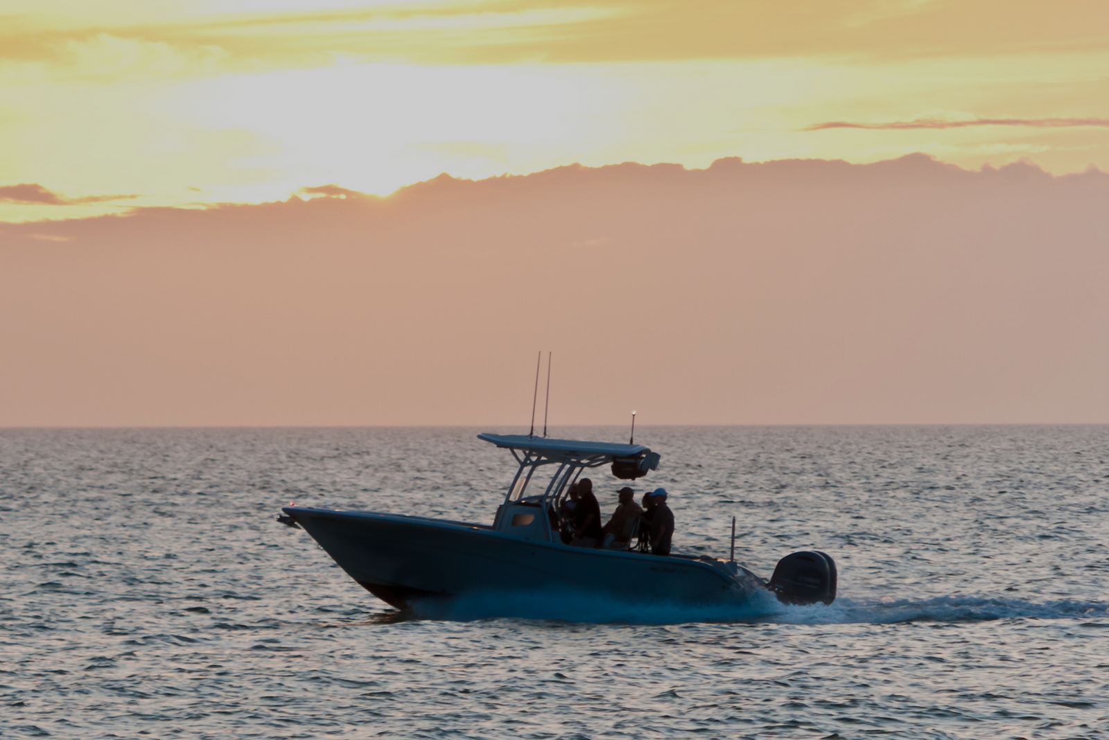 A boat cruising on open water, symbolizing the environmental and seasonal challenges charter captains must navigate.