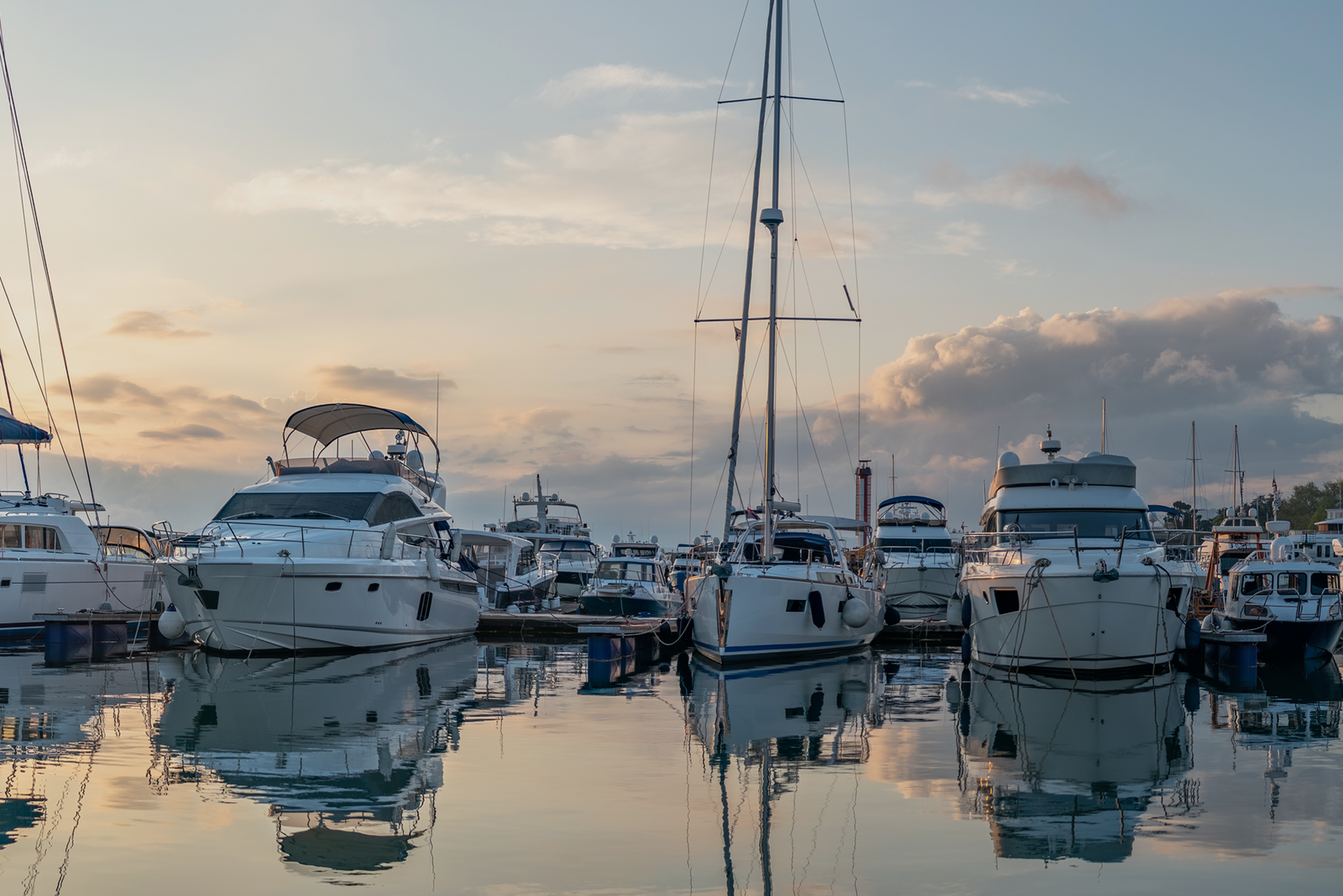 Several boats docked in a calm harbor, representing profitable charter business models for new captains.