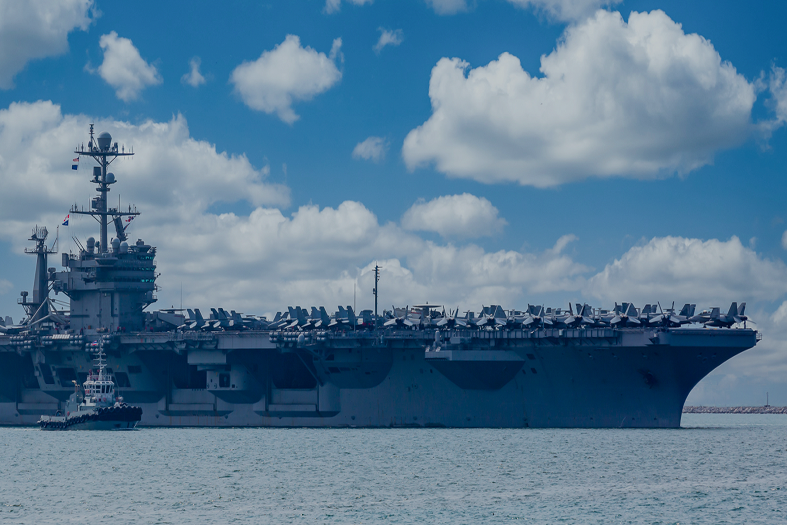 Large ship on open water with smaller vessel nearby, illustrating how to use military experience as sea service.
