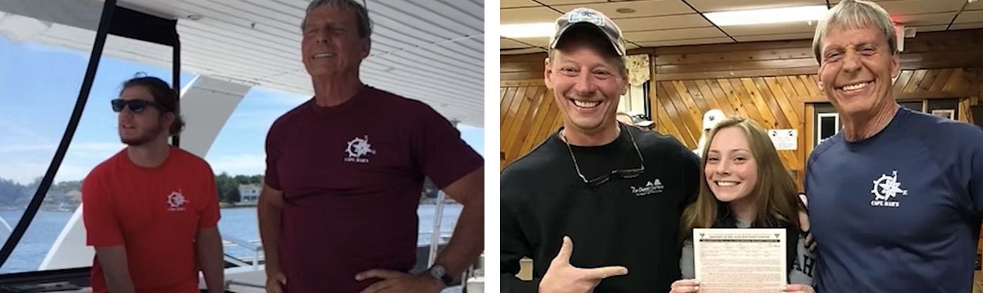 A man in a maroon shirt with a captain's wheel logo stands on a boat with a younger man in a red shirt.