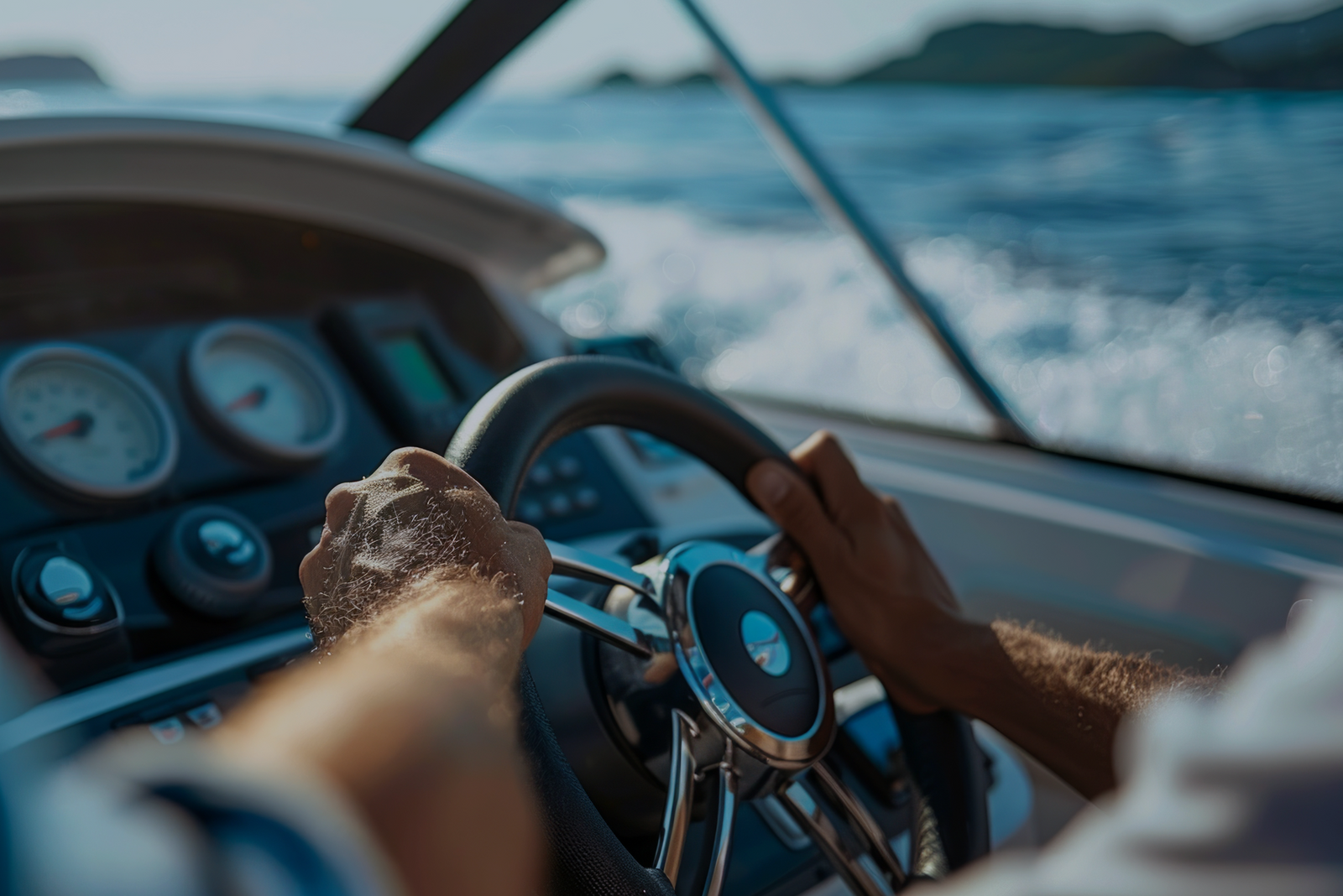 A boater steers from a center console with gauges and open water ahead, illustrating the types of USCG captain’s licenses and vessel operation.