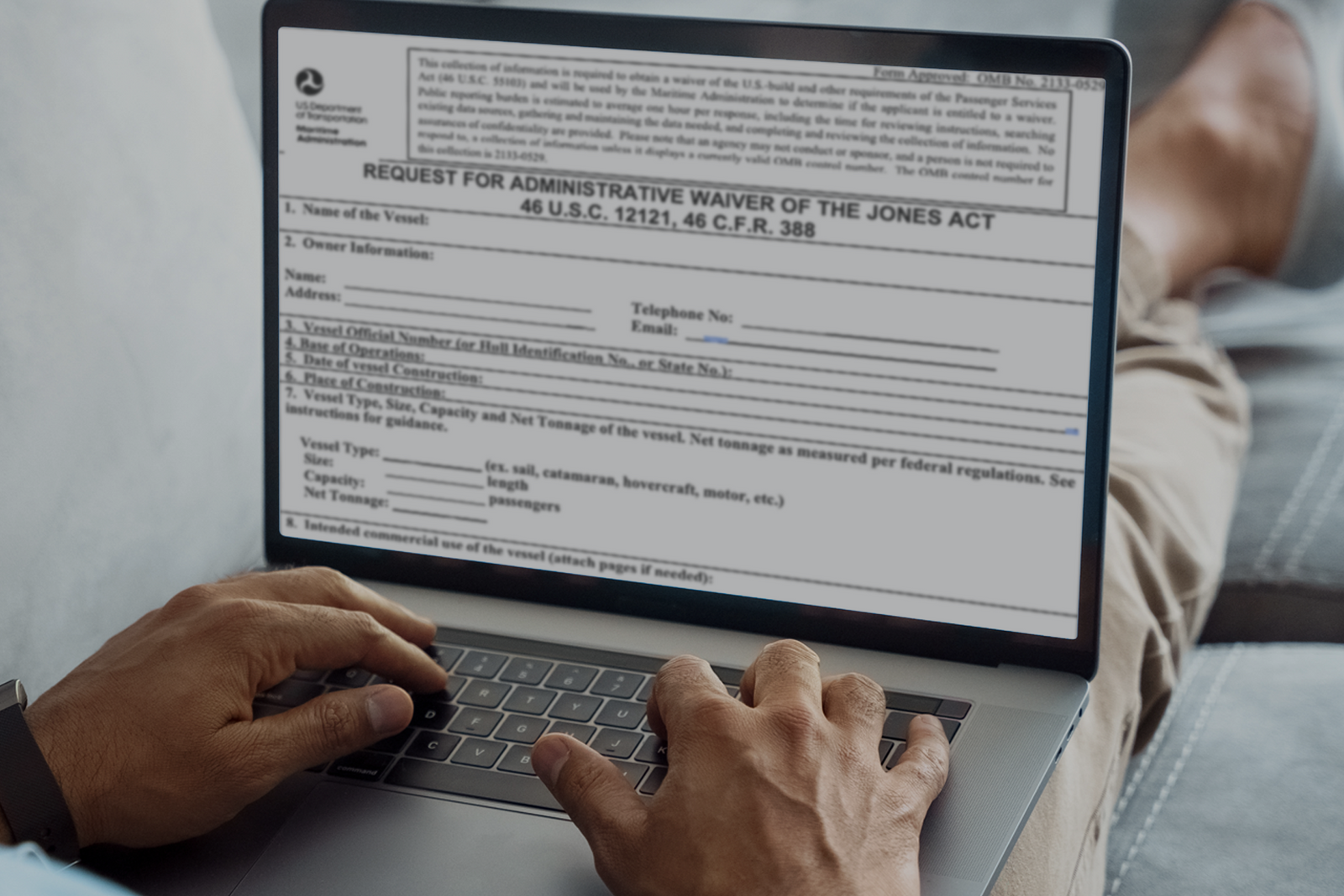 Open laptop showing webpage titled “Request for Administrative Waiver of the Jones Act” with legal form visible.