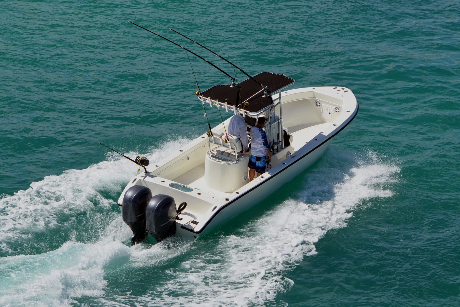 Two people on a boat in the open water, demonstrating how long a captain’s license is good for.