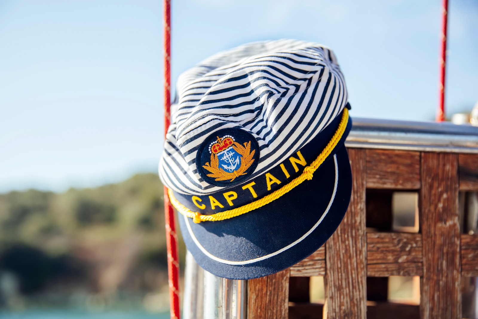 Captain’s hat with striped top and navy brim.