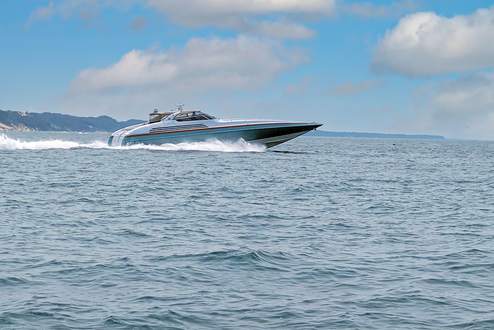 A boater drives their powered vessel on the water after earning a captain’s license in Michigan.