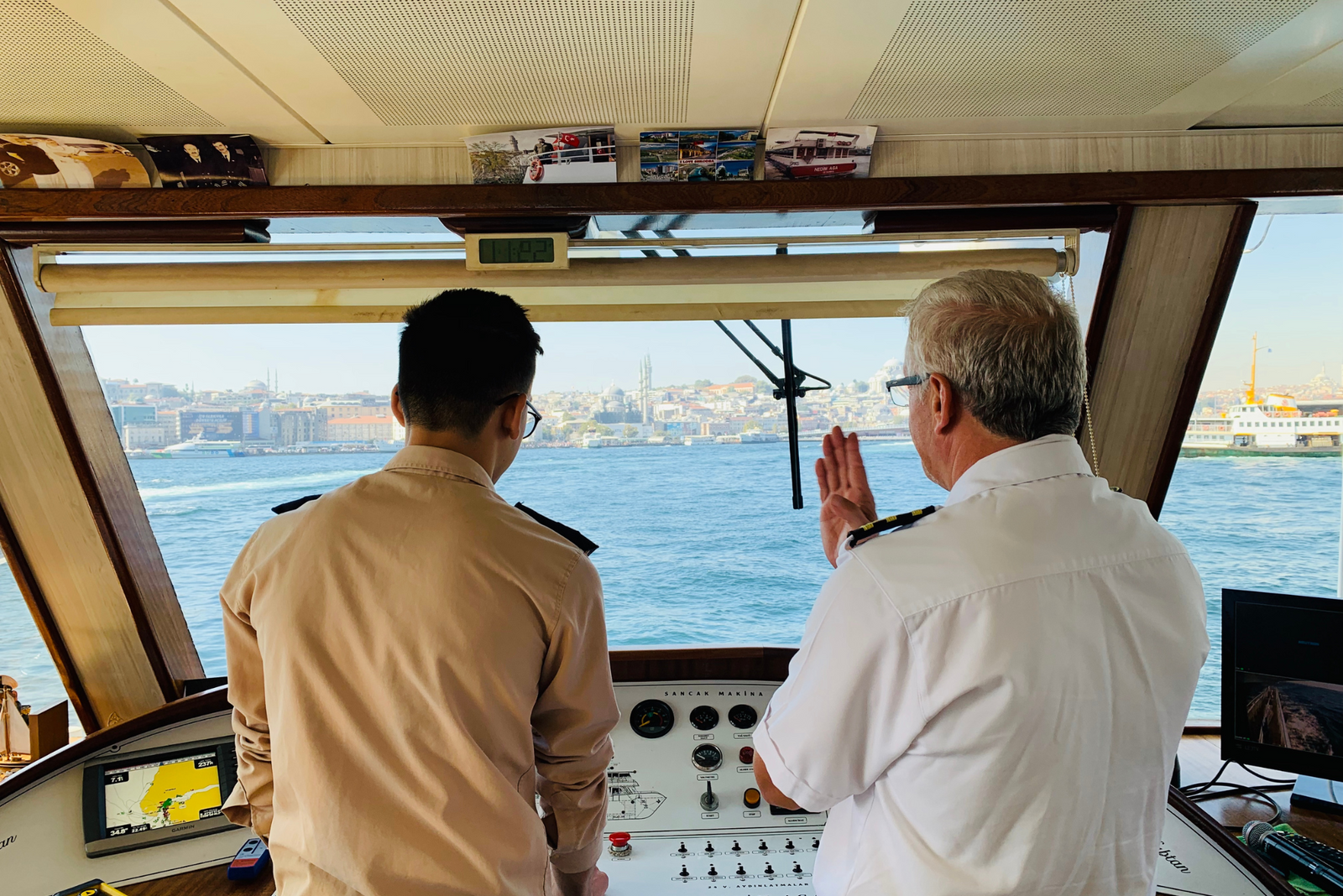 Two captains discussing navigation and safety protocols in a commercial charter’s control room.