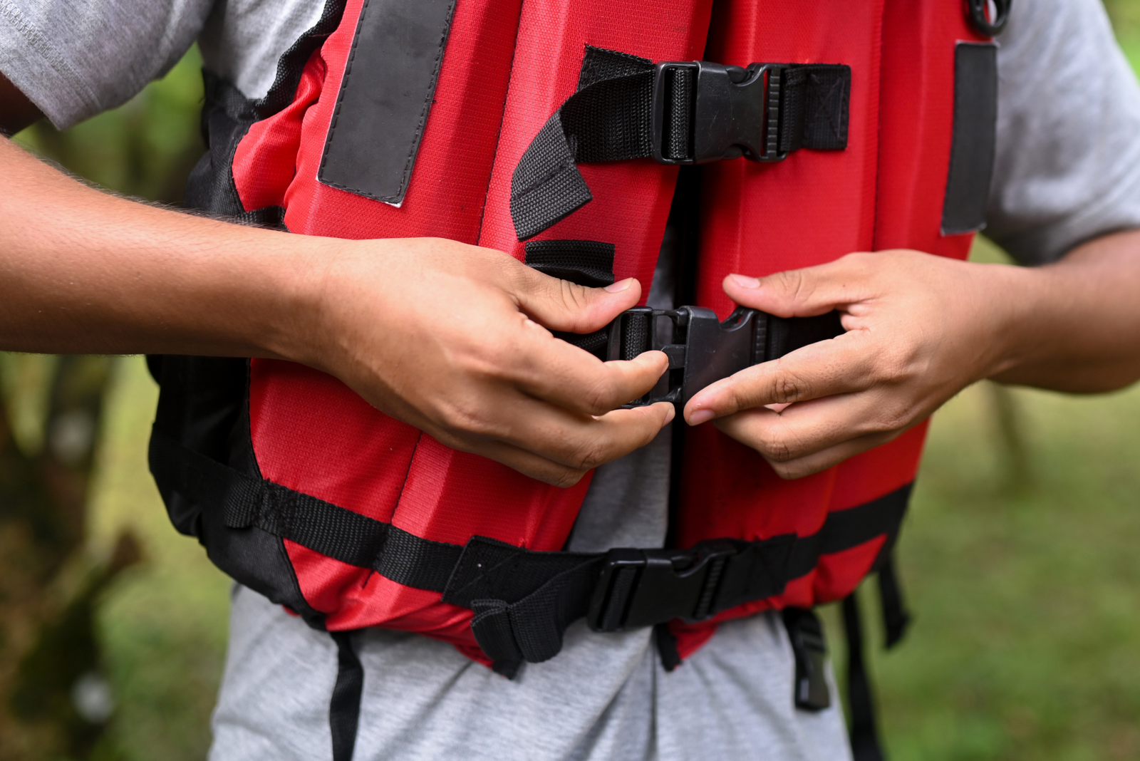 A man wearing a life jacket, questioning how old you have to be to not wear a life jacket.