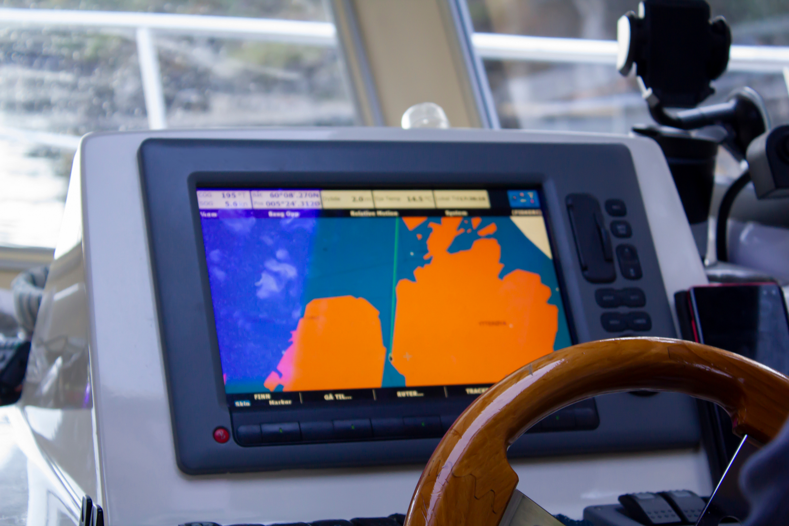 A close-up of a boat's GPS navigation system displaying a map.