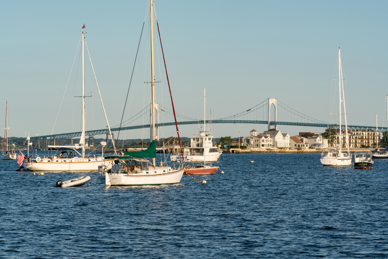 Sailboats and vessels anchored in harbor.