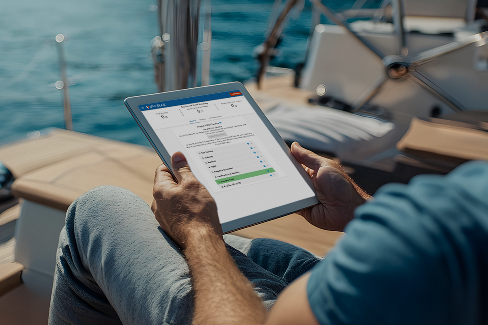 Man holding a tablet on a boat.