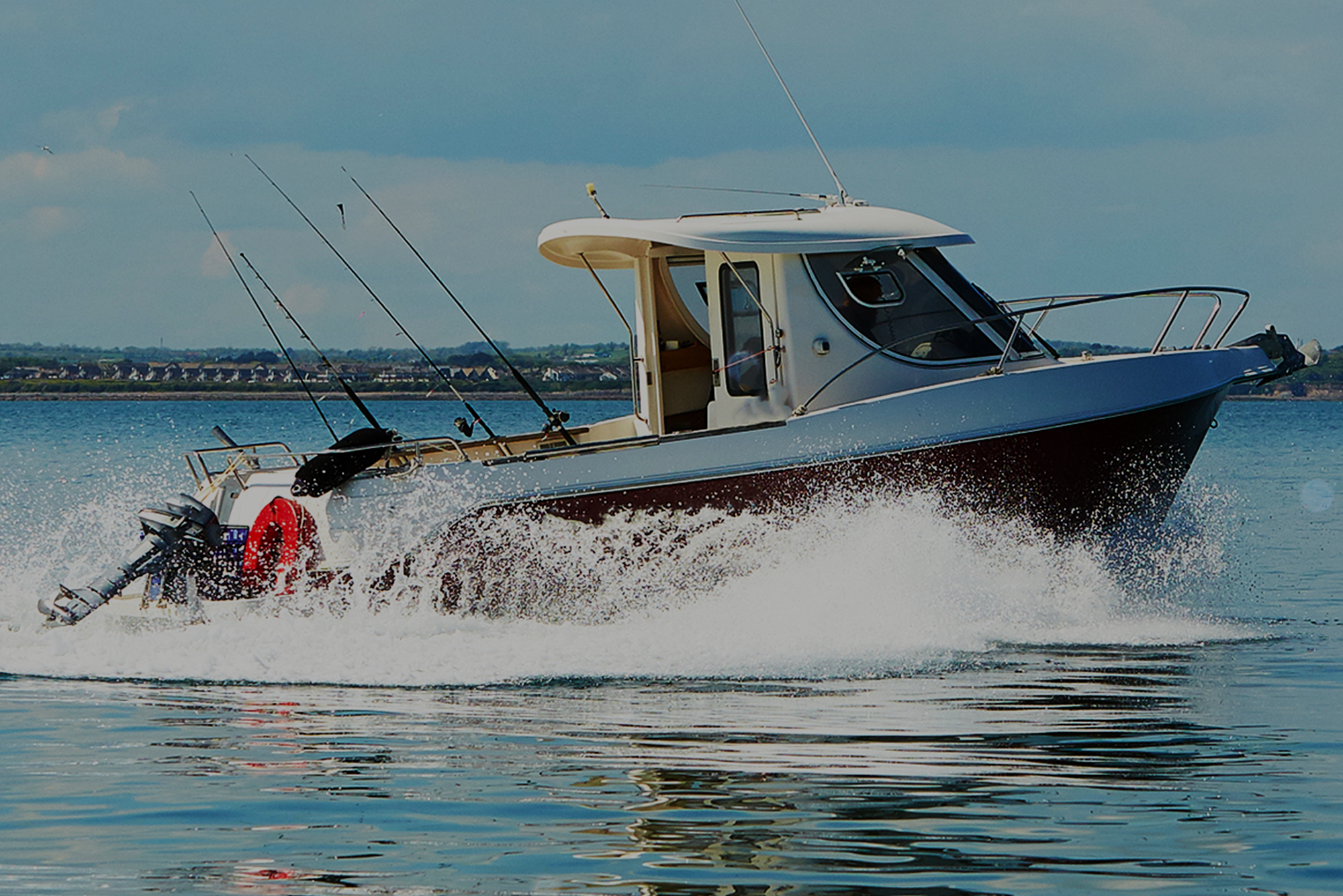 A fishing boat cruising through the water, creating a splash.