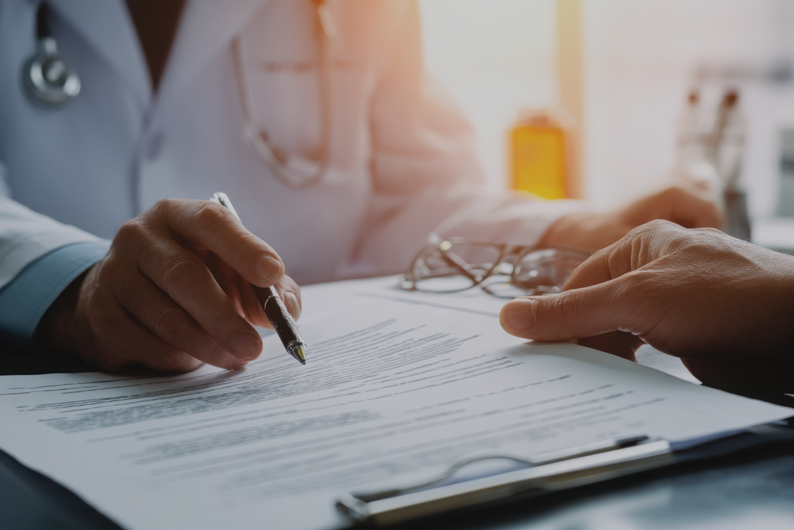 Close-up of a doctor and patient going over captain’s license drug test documents.