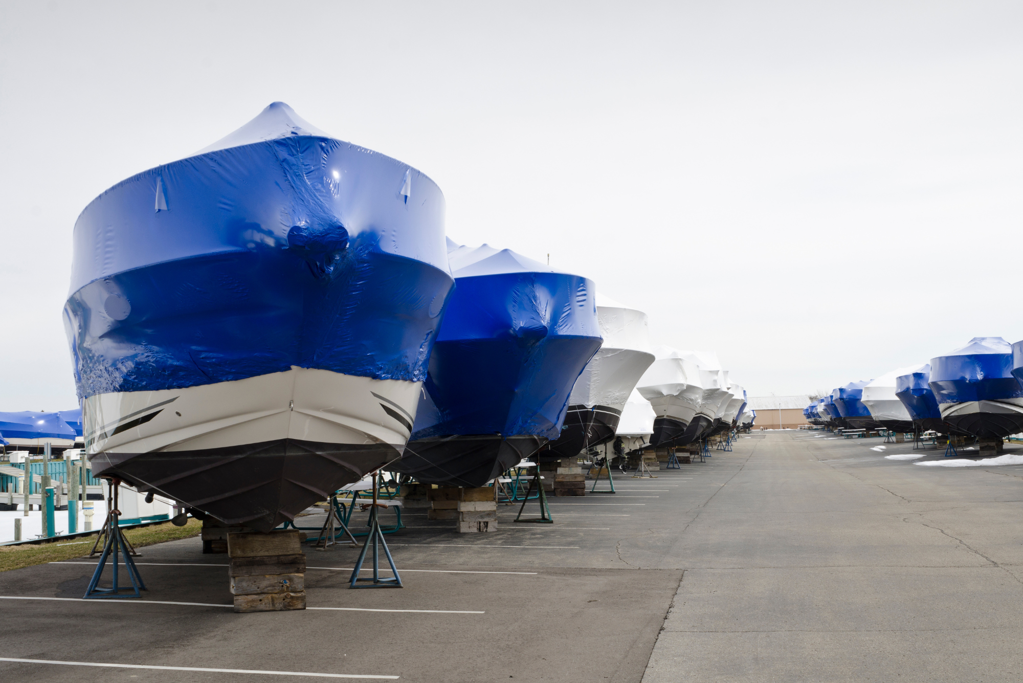 Several boats sit stored on land after their owners learn how to properly winterize a boat.