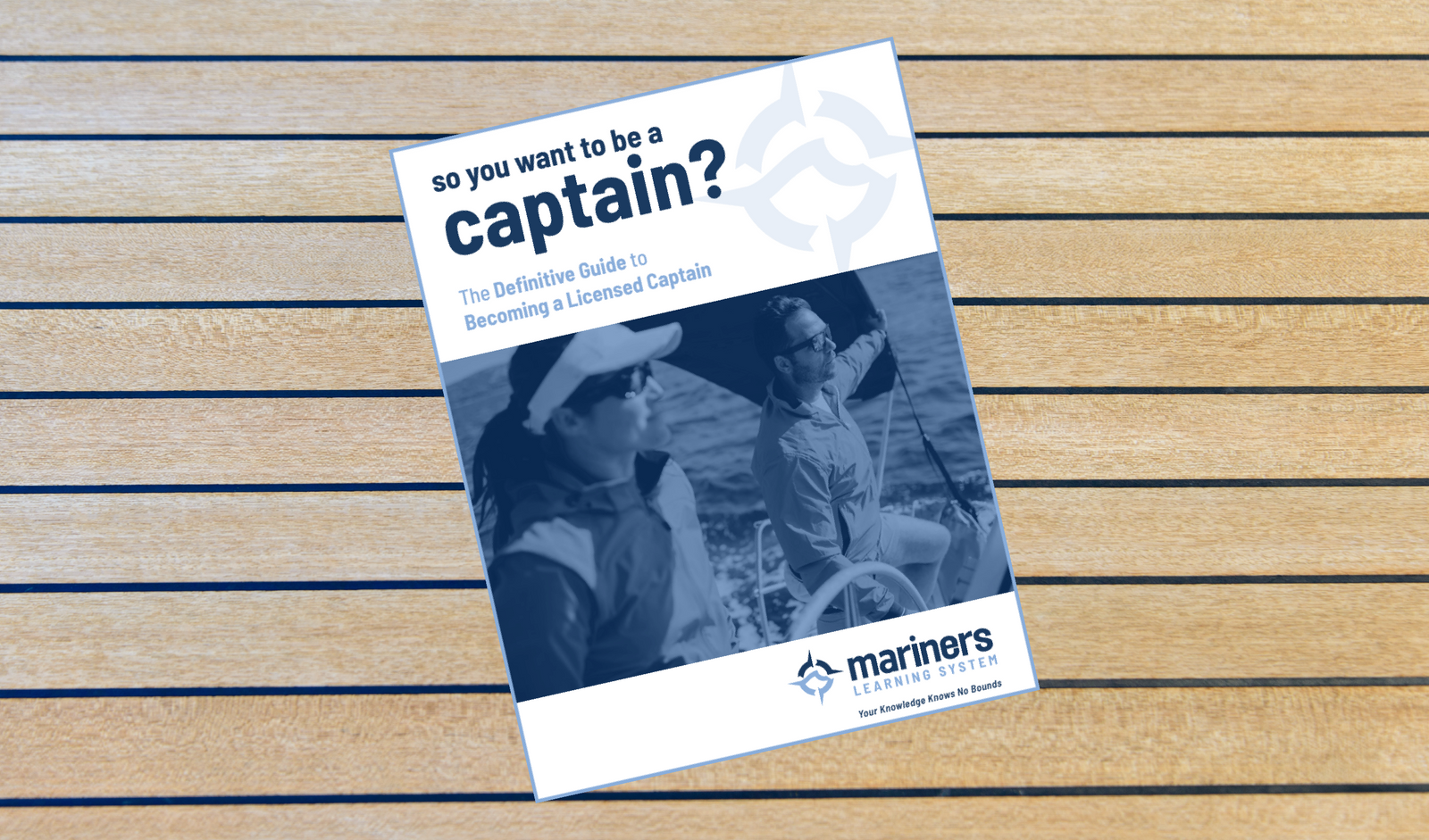 Booklet titled 'So You Want to Be a Captain?' on a wooden surface