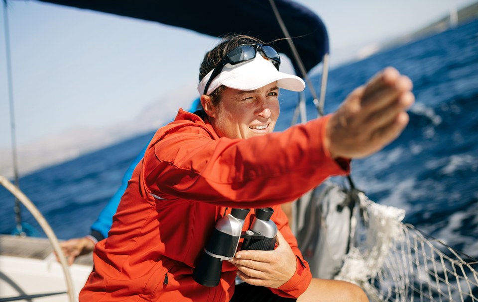 woman with binoculars on boat
