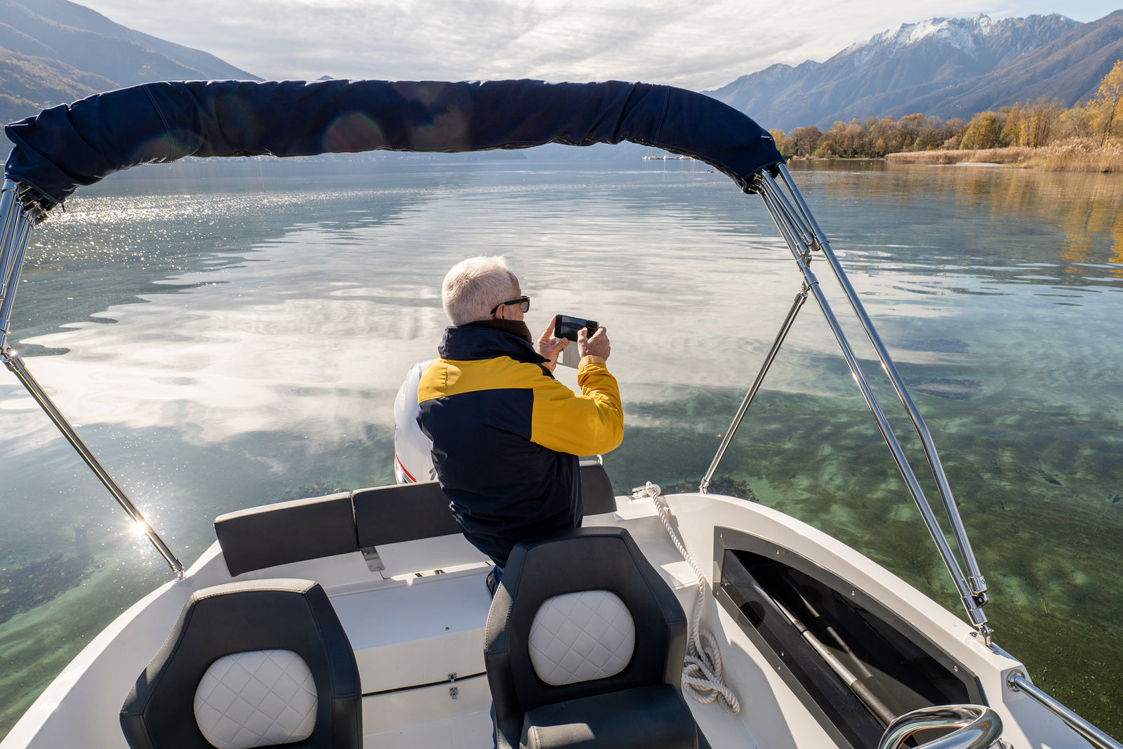 man taking a picture while on boat