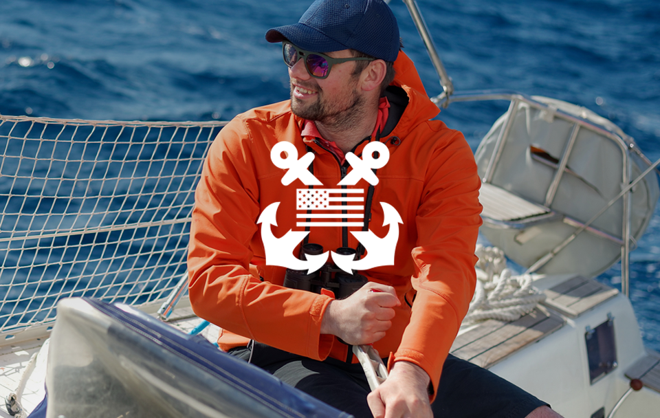 man on boat with anchors and flag icon in front
