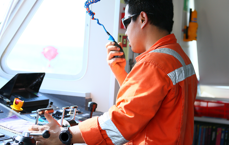 man on radio operating boat