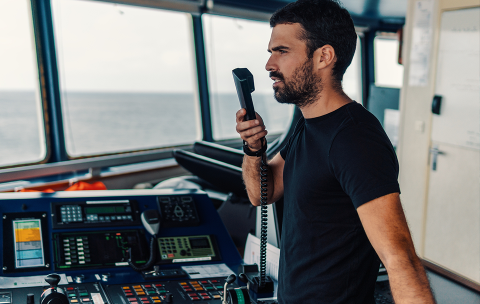 man on phone operating boat