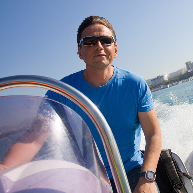 man driving motorboat