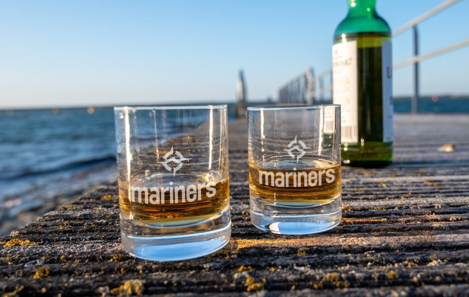 whiskey glasses on a dock