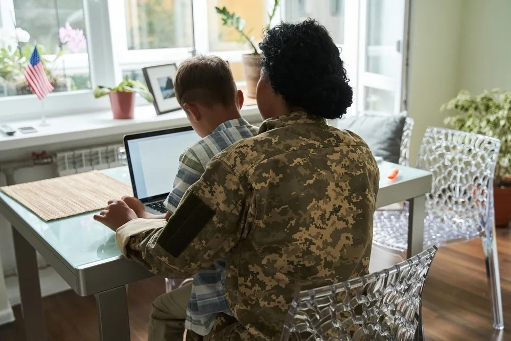 veteran and son using computer 